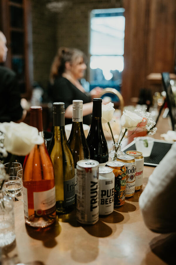 Friendly bartender from Simple Bar pouring drinks for guests at a private event.