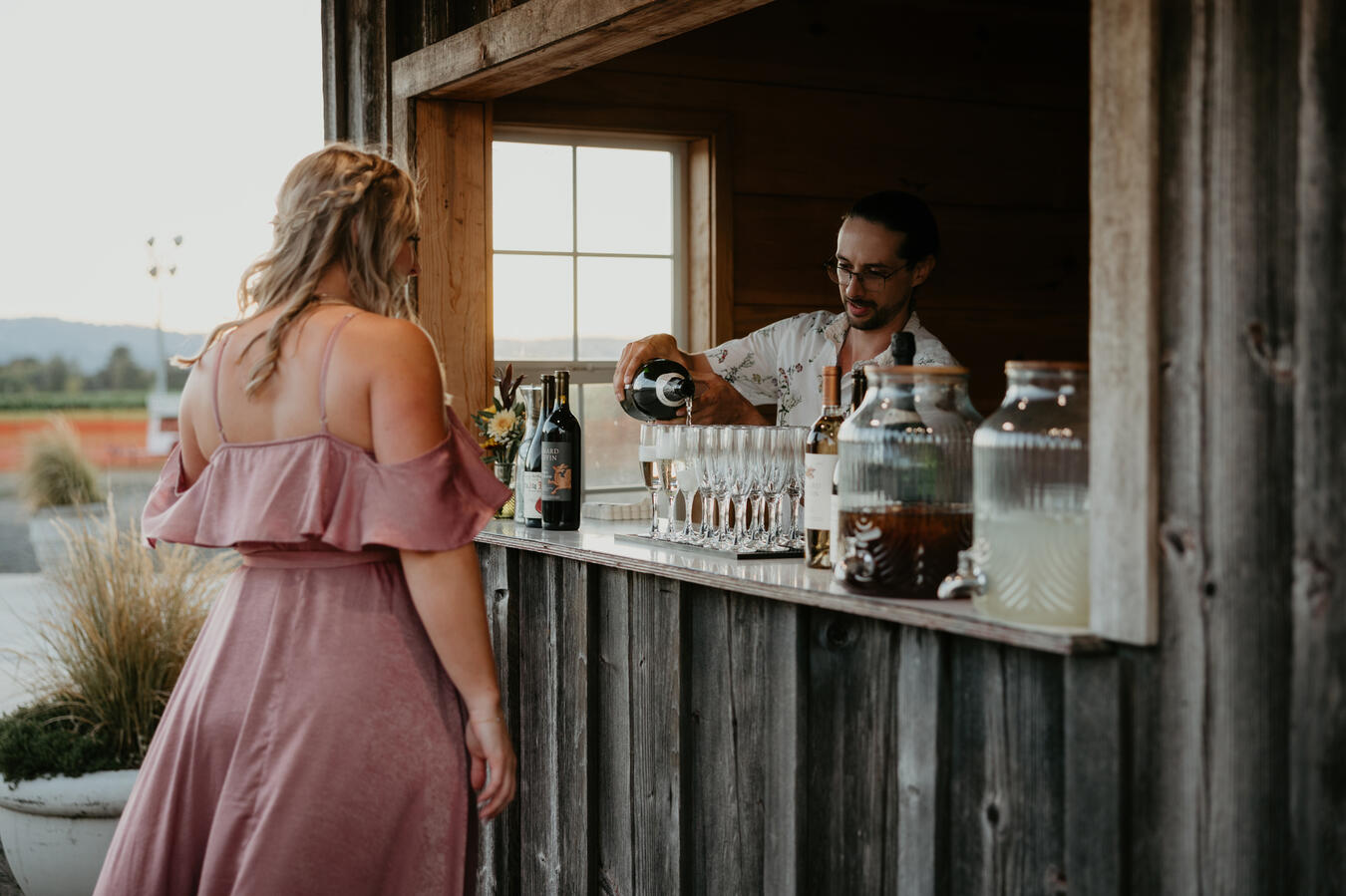 Simple Bar bartender serving craft cocktails to wedding guests at a reception.