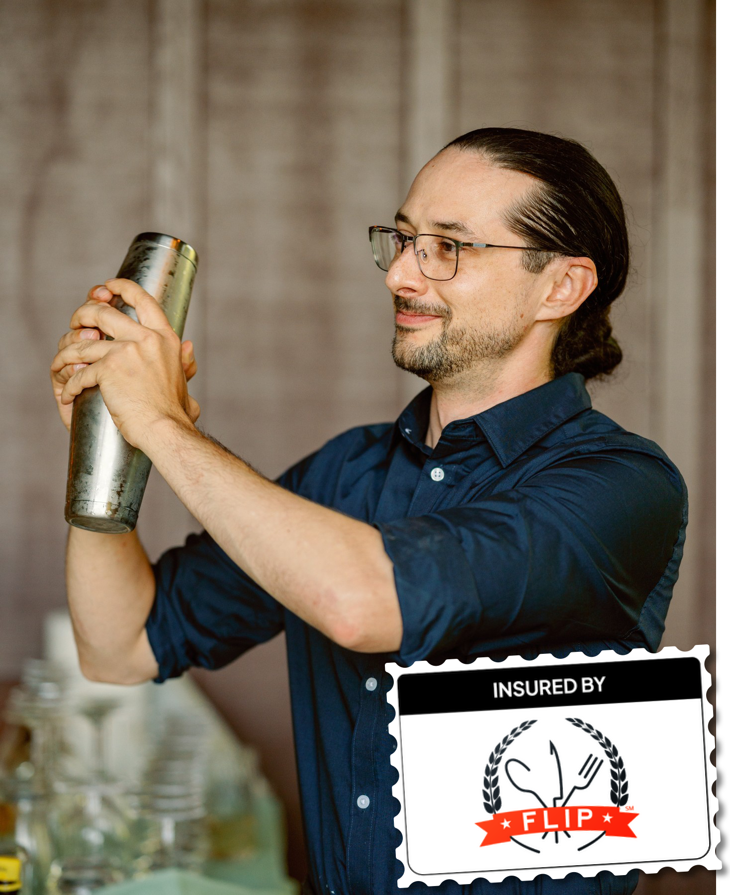 Professional bartender from Simple Bar mixing drinks behind a mobile bar setup.